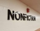 Acrylic lettering on an interior brick wall.