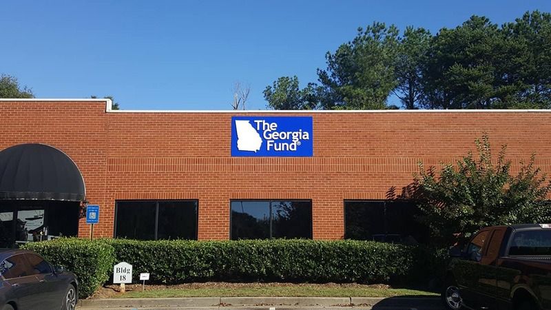 Acrylic block sign on a brick wall.