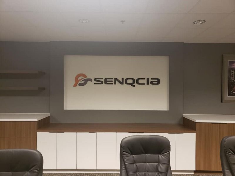 Company logo on a wall in a conference room.