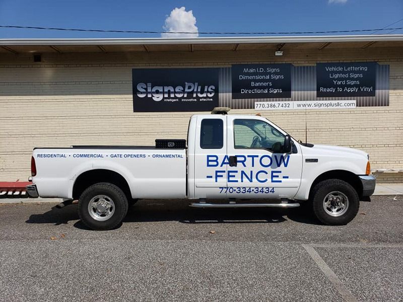 Decals on the side of a white truck.