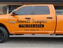 Script decals on the side of a yellow truck.