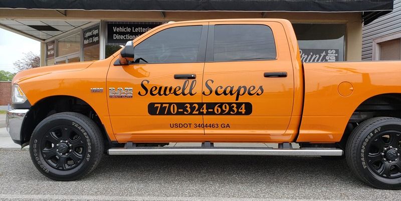 Script decals on the side of a yellow truck.