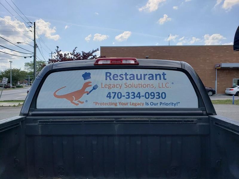 Perforated print on a rear window of a truck.