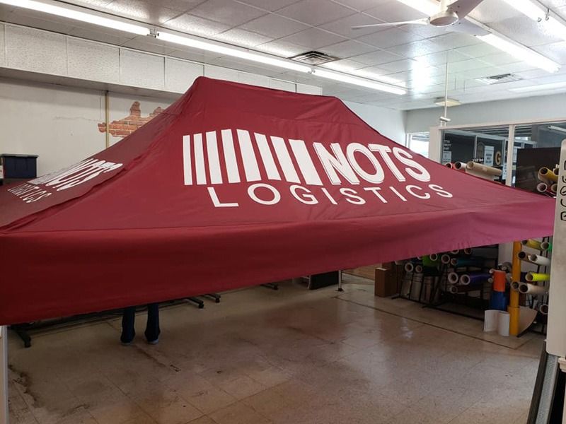 Portable tent with company branding.