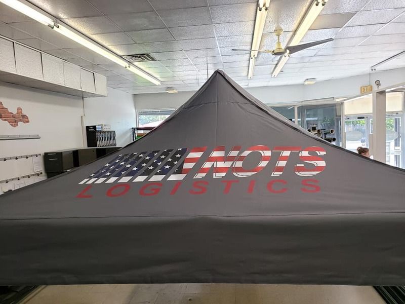 Portable tent with company branding.