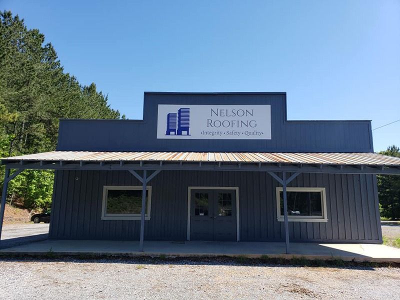 Wide shot of an overhead sign for a roofing company.